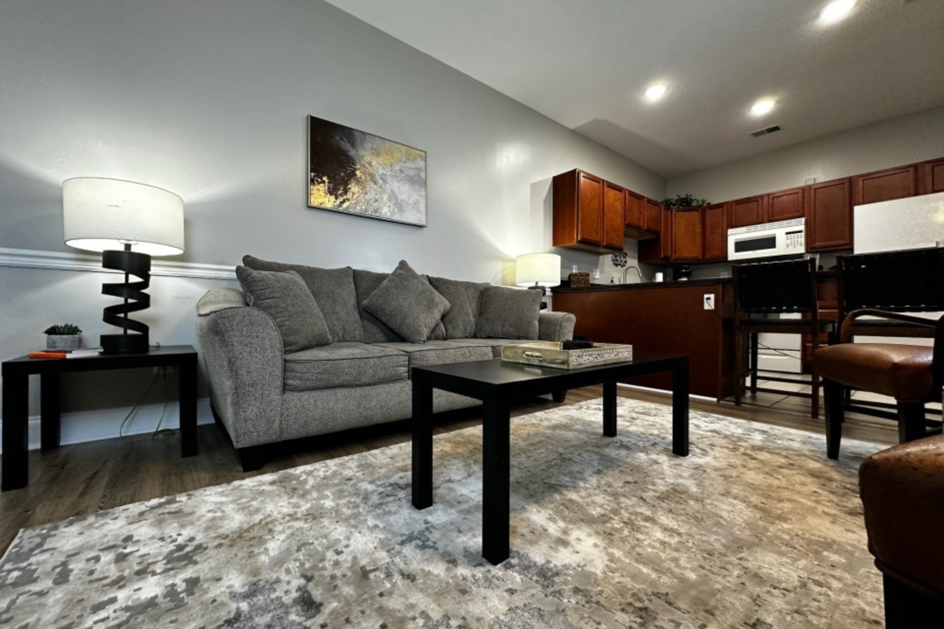A living room with a couch , coffee table , and rug.