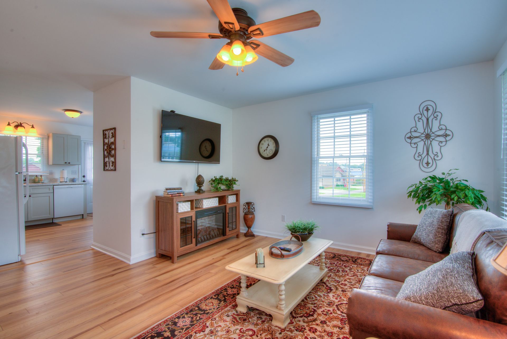 Gorgeous living room with brown leather couches, entertainment center, and TV in TN Livin's Johnson City Home for short-term renting