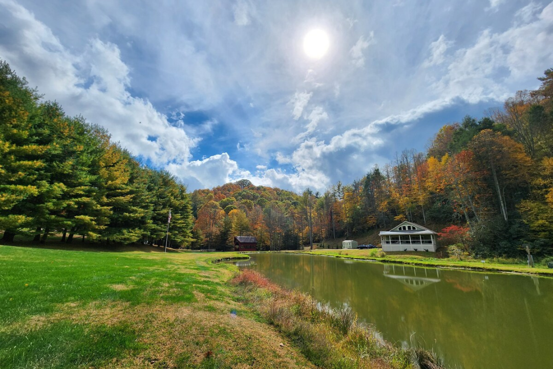 Proprety shot of TN Livin's Hampton Home including beautiful covered bridge & pond stocked with fish
