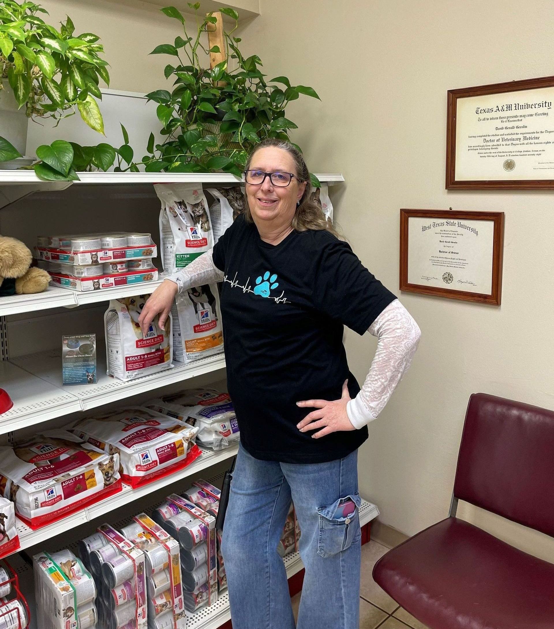 Veterinary clinic receptionist Cheryl standing in front of pet food