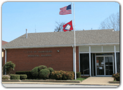 An american flag is flying in front of a brick building