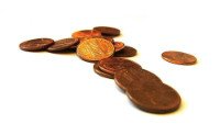 A pile of coins on a white surface.