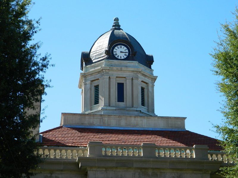 A large building with a dome and a clock on top