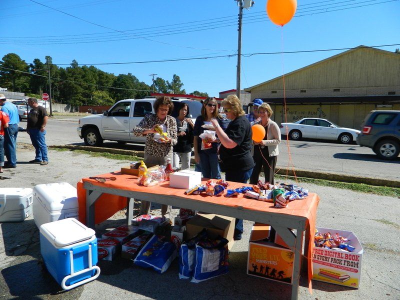 A group of people are gathered around a table with a box that says texas on it