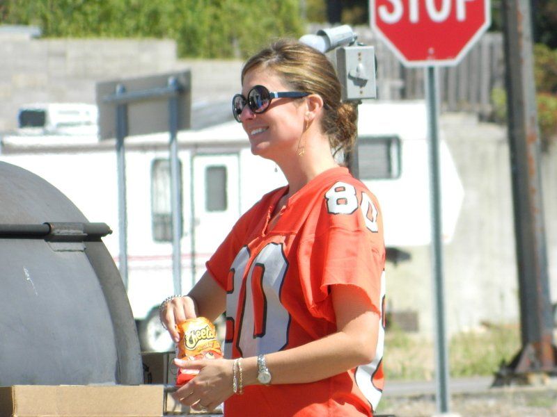 A woman wearing an orange jersey with the number 81 on it
