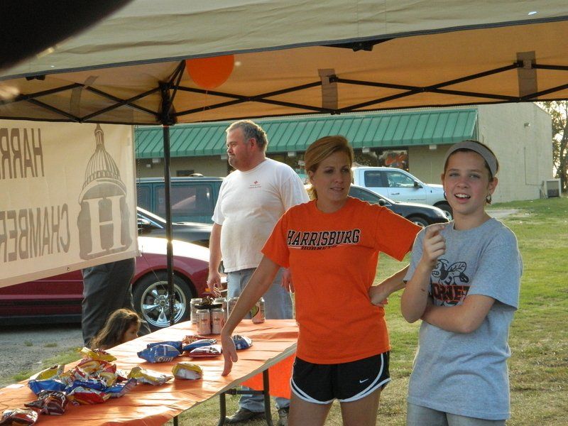A woman wearing an orange shirt that says ' ferris state ' on it