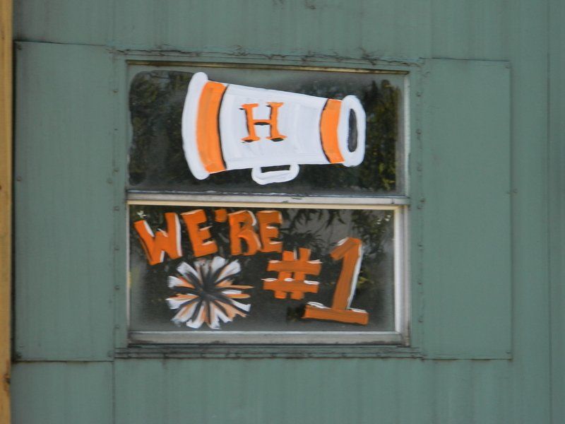 A window with a megaphone and the words we 're # 1 painted on it