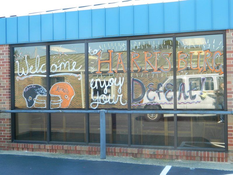 A brick building with a window that says welcome harrison enjoy your day