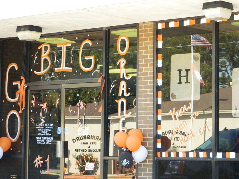 A store front with balloons and a sign that says big