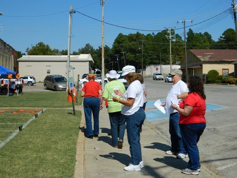 A group of people are walking down a sidewalk