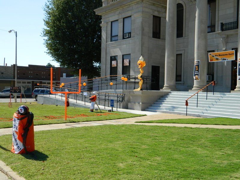 A large building with stairs and a sign that says 