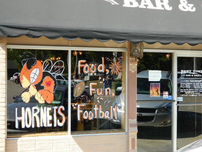 A store front with hornets football written on the window
