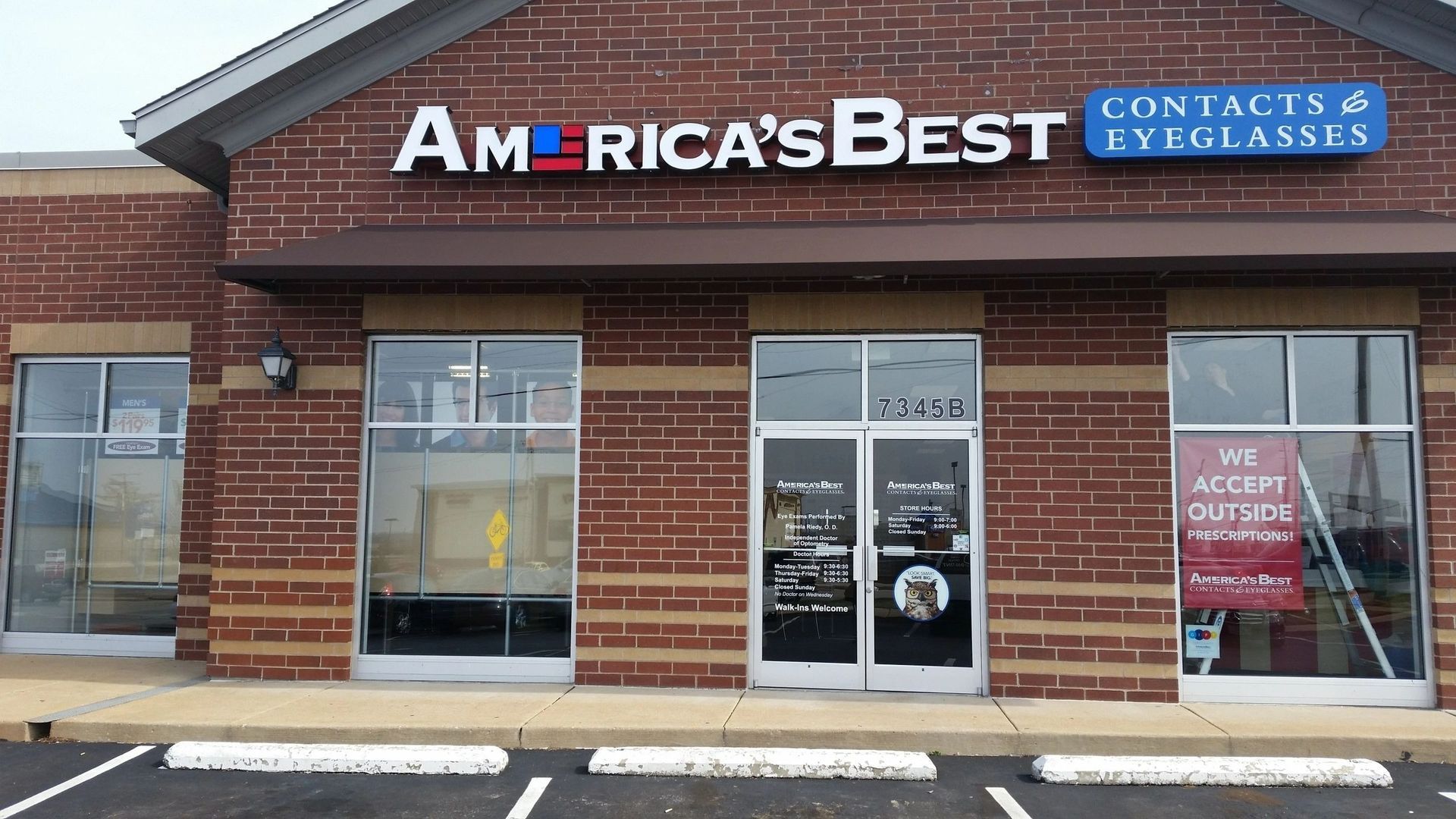 America's Best Contacts & Eyeglasses storefront in a brick strip mall with glass doors and windows