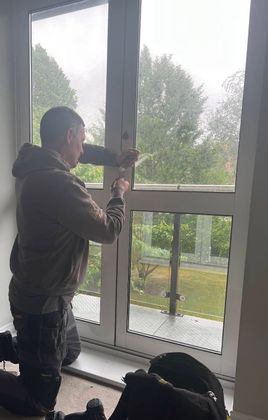 Locksmith working on a jammed balcony door lock in Bromley using non-destructive entry methods on an older aluminium door mechanism during a residential locksmith callout by The Key Locksmith.