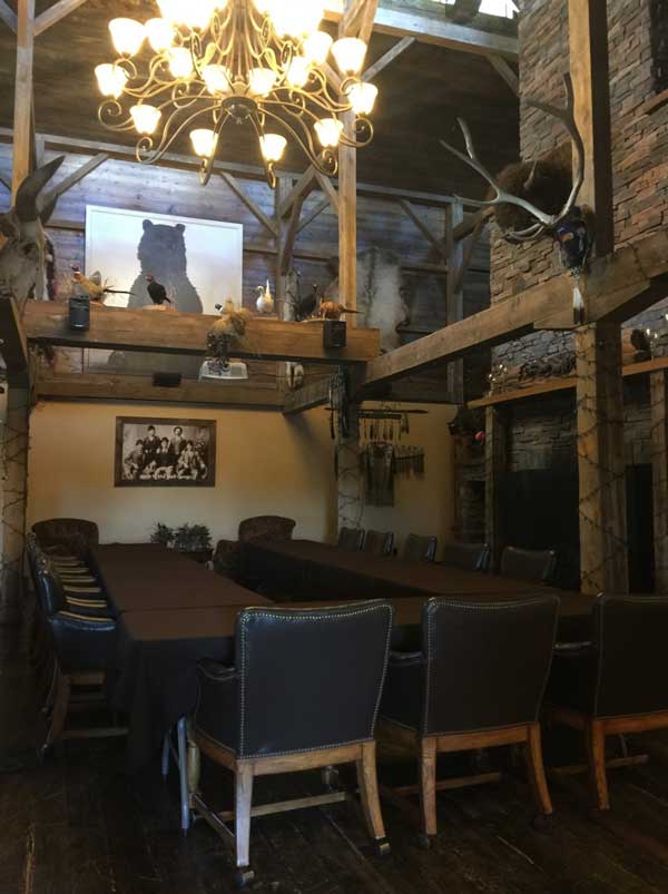 A large room with a table and chairs and a chandelier