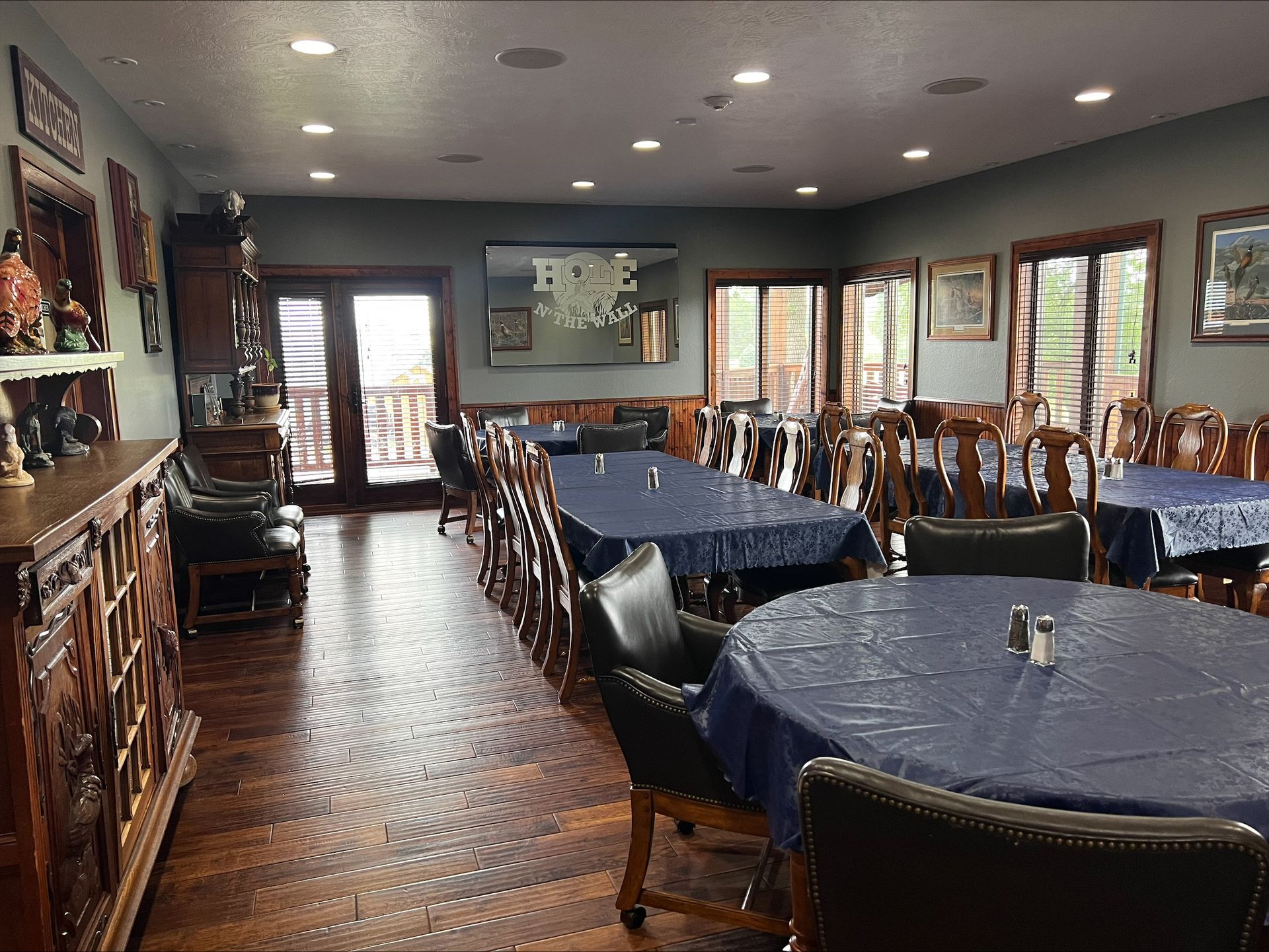 There are many tables and chairs in this large room.