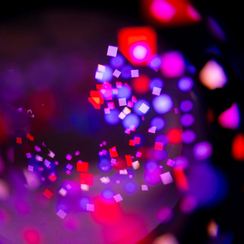 Abstract swirl of neon squares and spots.