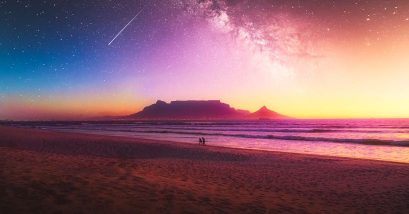 Table Mountain in Africa, viewed from a beach at sunset