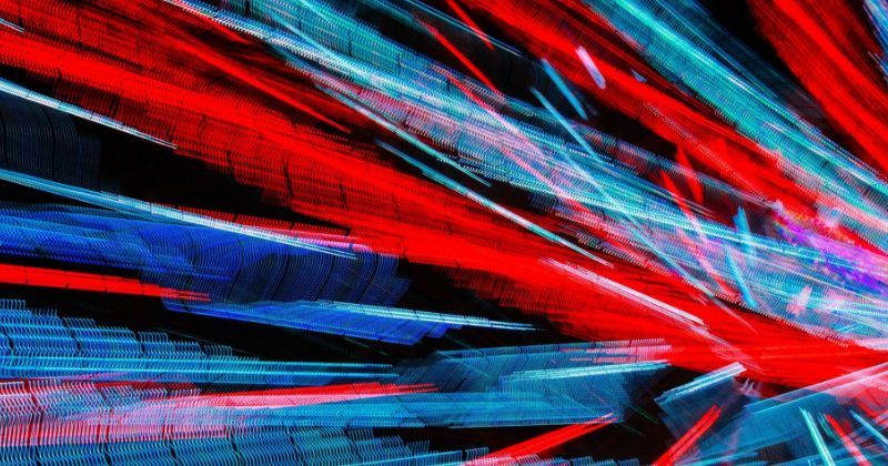 An abstract image of red and blue streaks and light traces