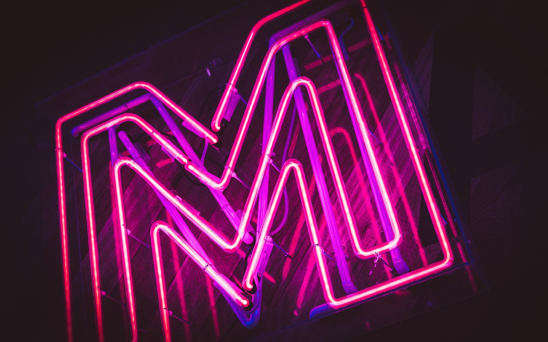 A neon 'M' light in purple