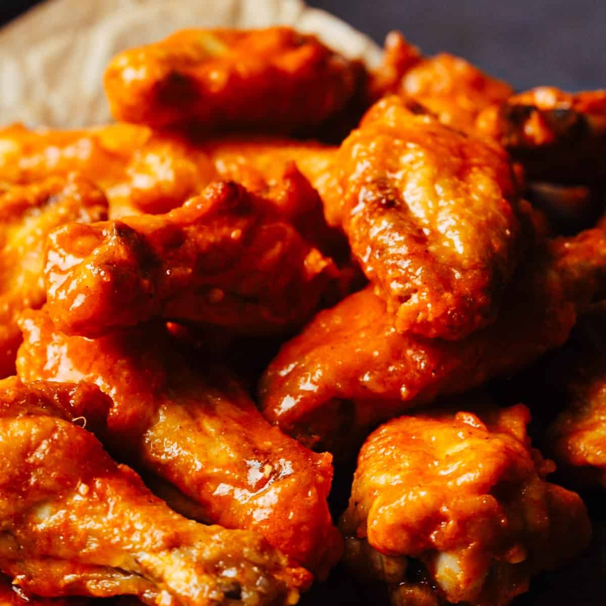 Appetizer platter: chips, cheese dip, wings, fried shrimp, and dipping sauces.