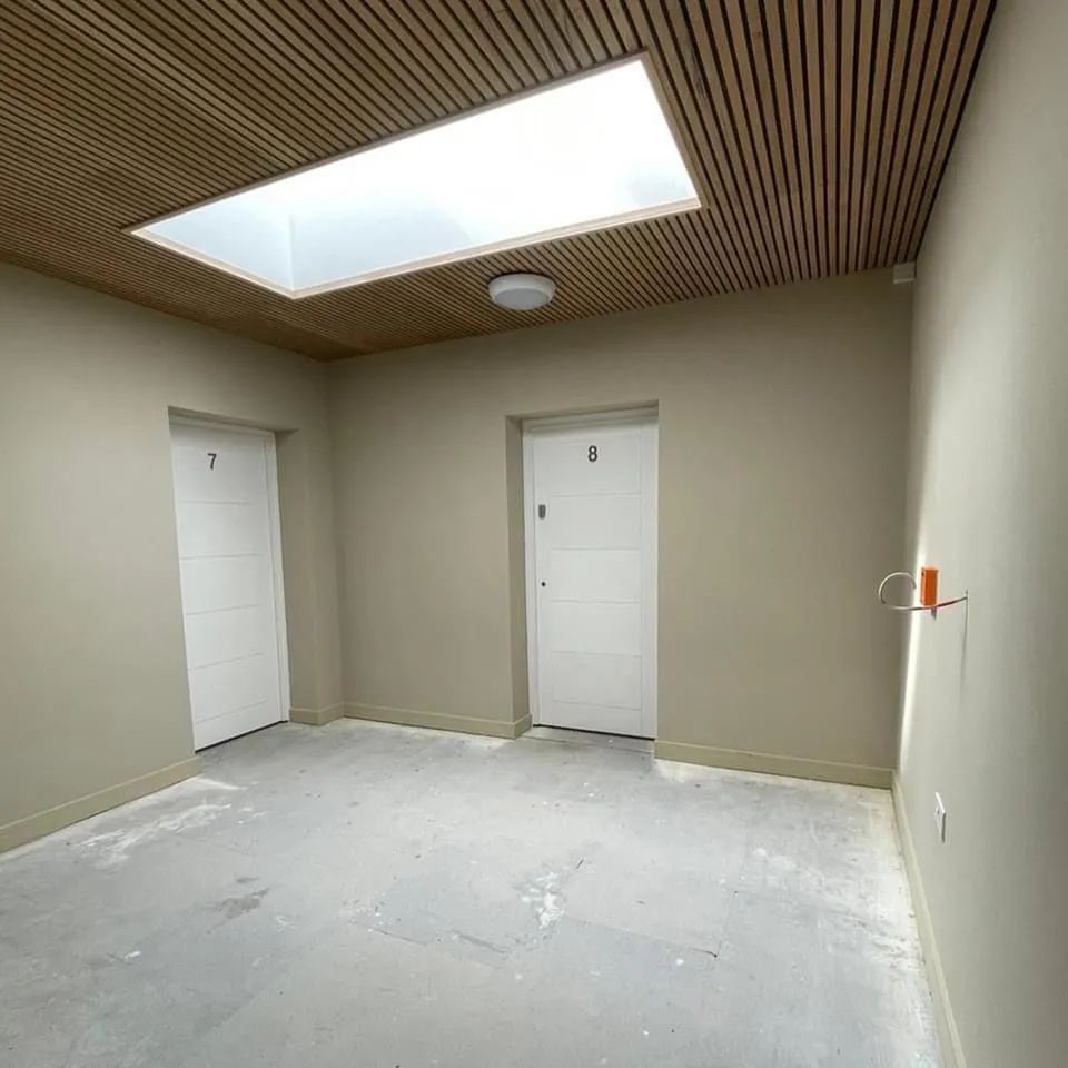 Hallway with skylight and two numbered fire doors