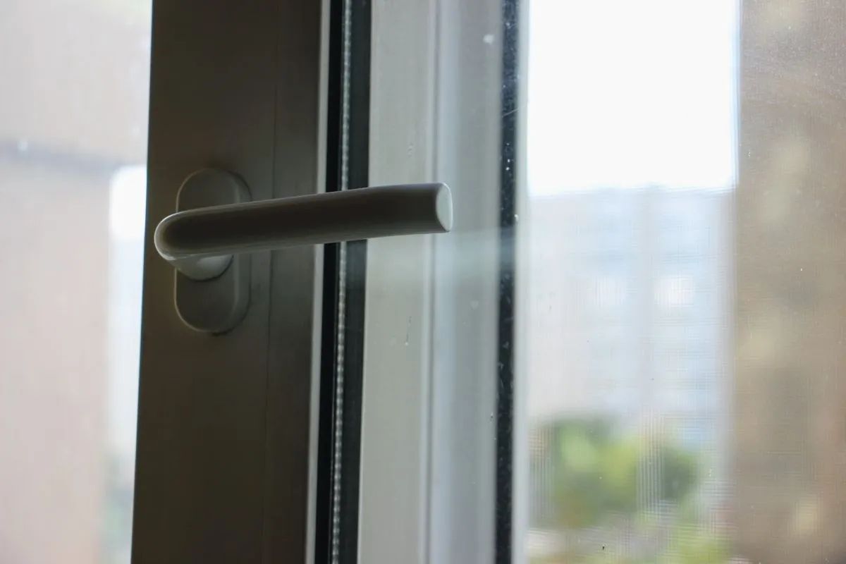Close-up of a UPVC window handle and hinge