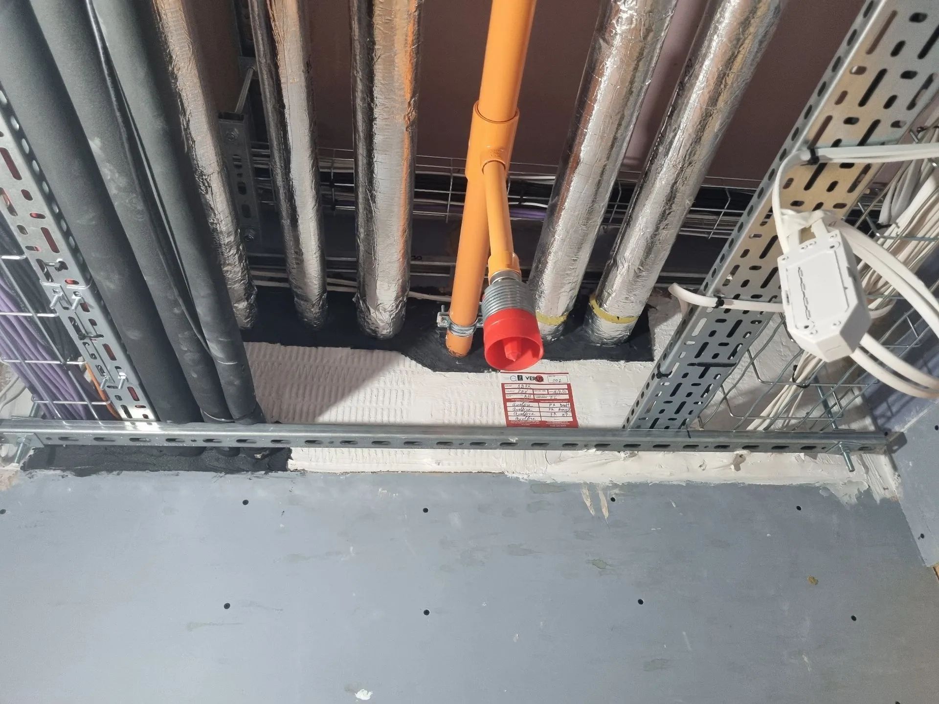 Verus Group fire-rated seal around a bundle of pipes and conduit