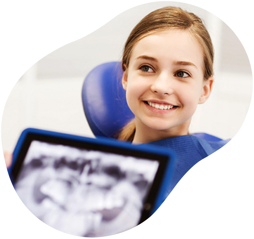 Smiling patient in a dental chair with an X-ray image in the foreground