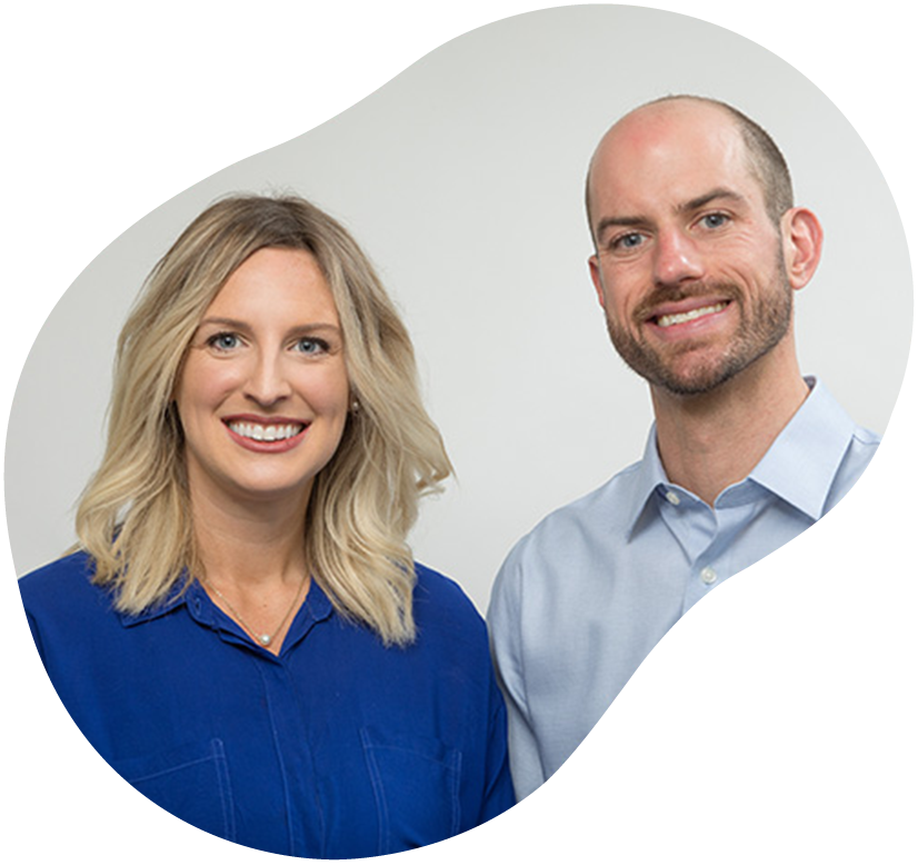 Two smiling professionals in blue shirts against a light gray background
