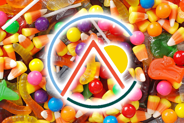 Colorful candies scattered around a glowing circular logo with a stylized red-and-white “A” in the center