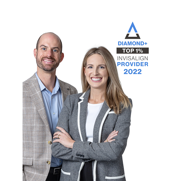 Two professionals posing with arms crossed beside a “Diamond+ Top 1% Invisalign Provider 2022” badge.