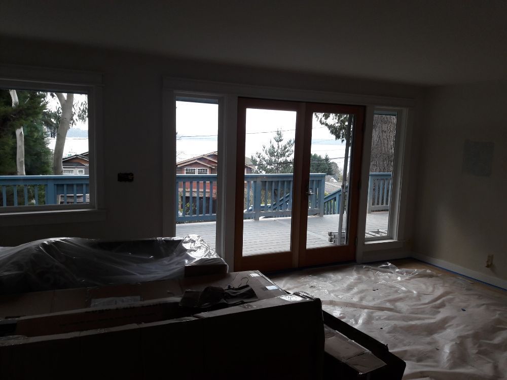 A living room with a couch and sliding glass doors leading to a deck.