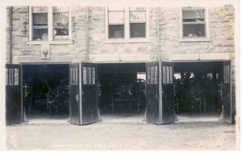 A postcard of the Swarthmore firehouse, bay doors open.