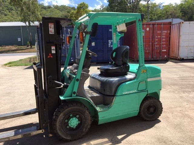 A Green Forklift is Parked in a Parking Lot — Kelly's Crane Hire in Mossman, QLD