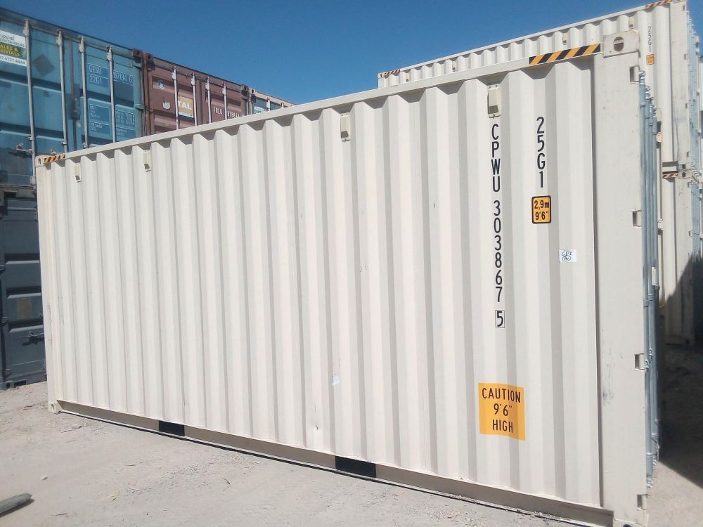 A Large White Shipping Container is Sitting in a Parking Lot — Kelly's Crane Hire in Mossman, QLD