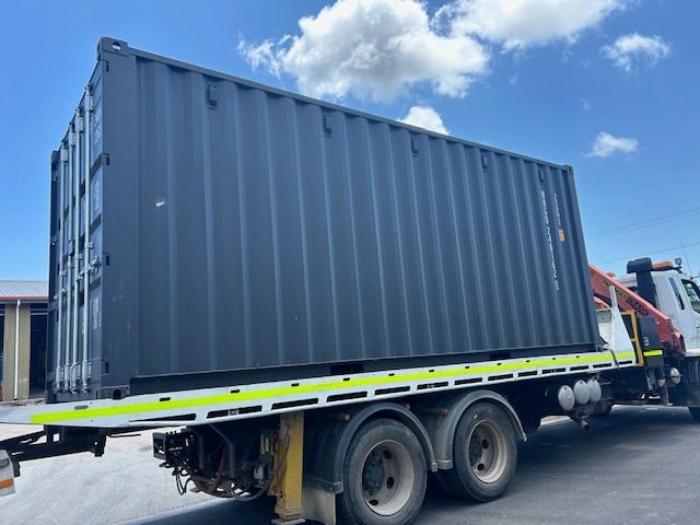 A Truck With a Blsck Container on the Back — Kelly's Crane Hire in Mossman, QLD
