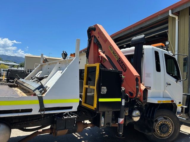 A Truck With a Crane Attached to It is Being Towed by Another Truck — Kelly's Crane Hire in Mossman, QLD