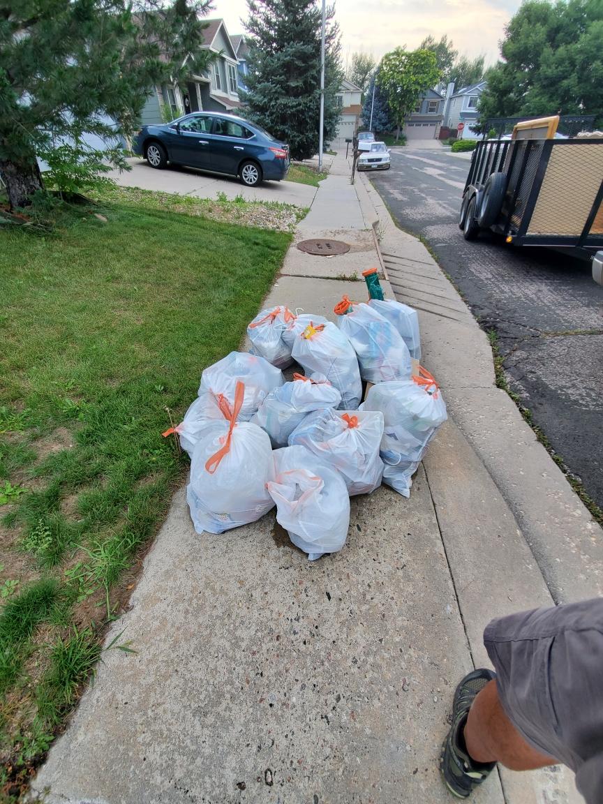 a pile of trash bags with yarde waste in them in colorado springs co