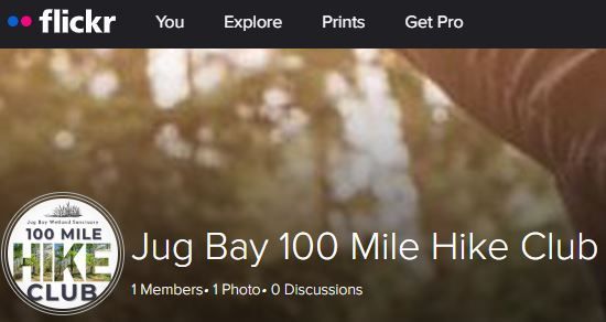 Flickr group banner for “Jug Bay 100 Mile Hike Club” with trail-themed logo and blurred outdoor background