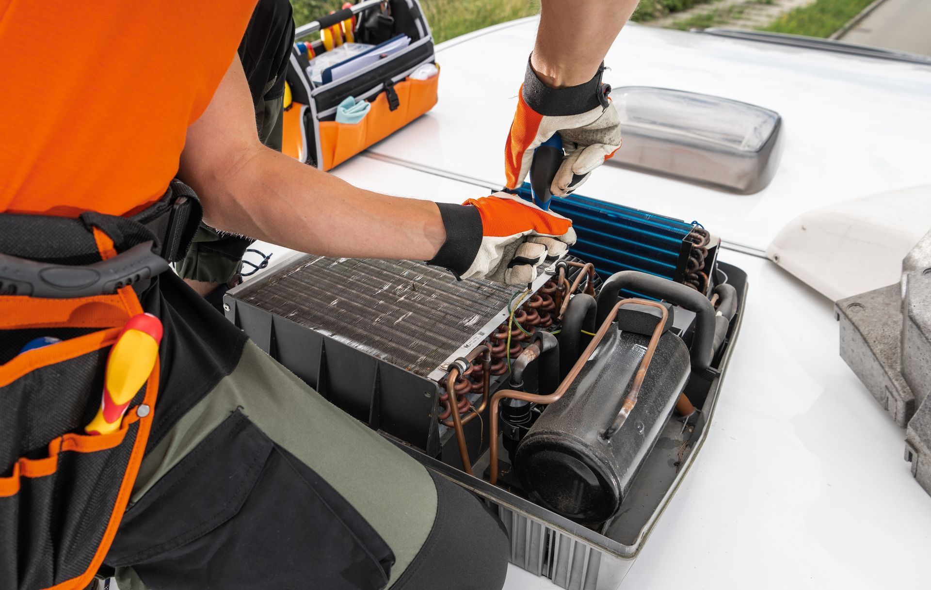 Hand cleaning an outdoor air conditioner unit with a spray bottle
