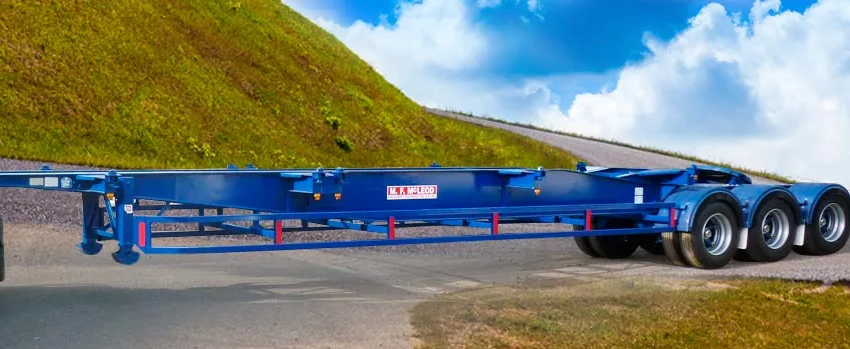 A blue trailer is parked on the side of a road. A blue trailer is parked on the side of a road.