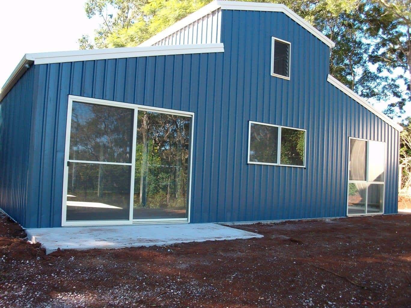 A Blue Building With Sliding Glass Doors And Windows — Just Sheds In Kunda Park, QLD