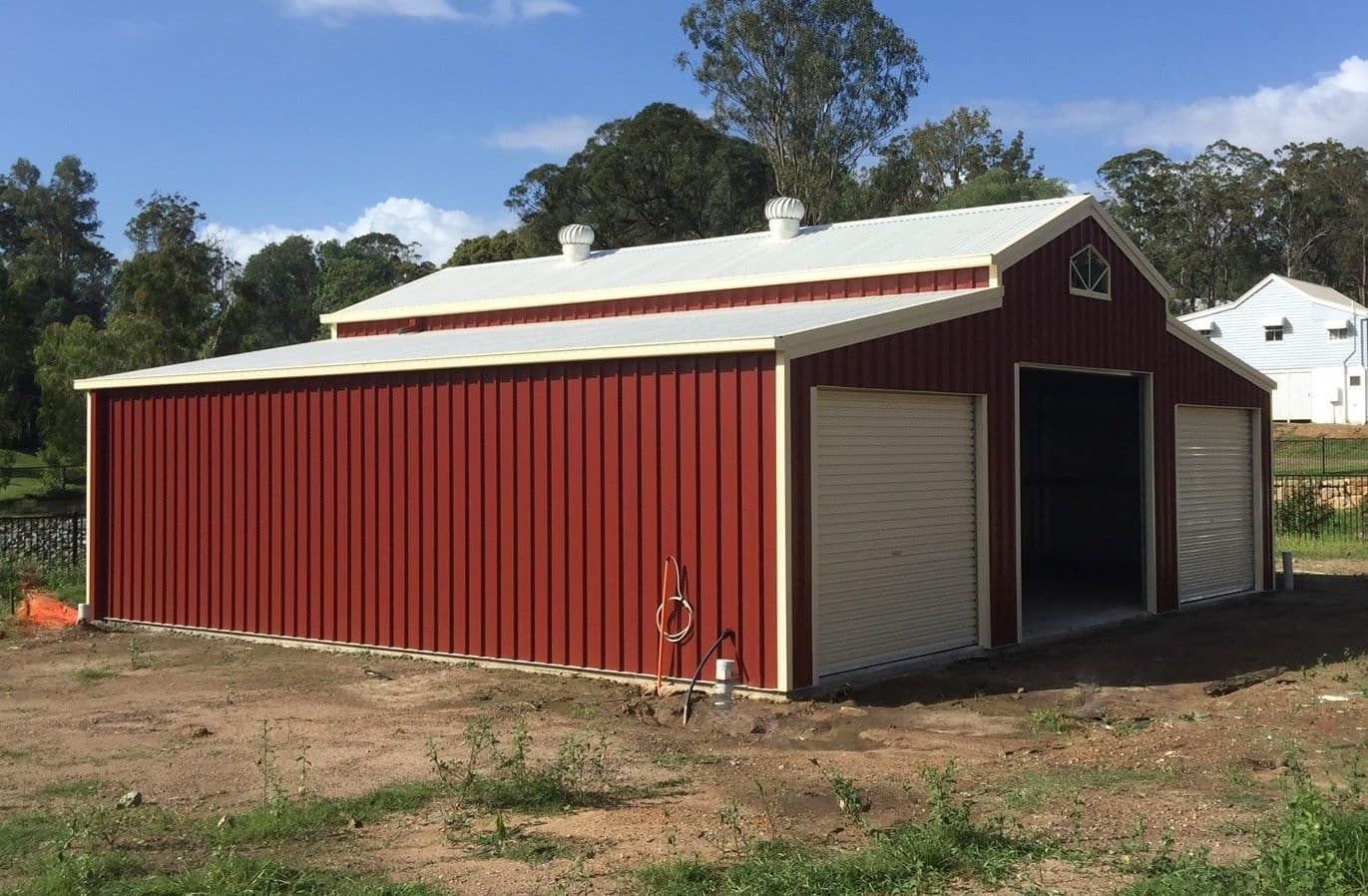 A Red Barn With A White Roof Is Sitting In The Middle Of A Field — Just Sheds In Kunda Park, QLD