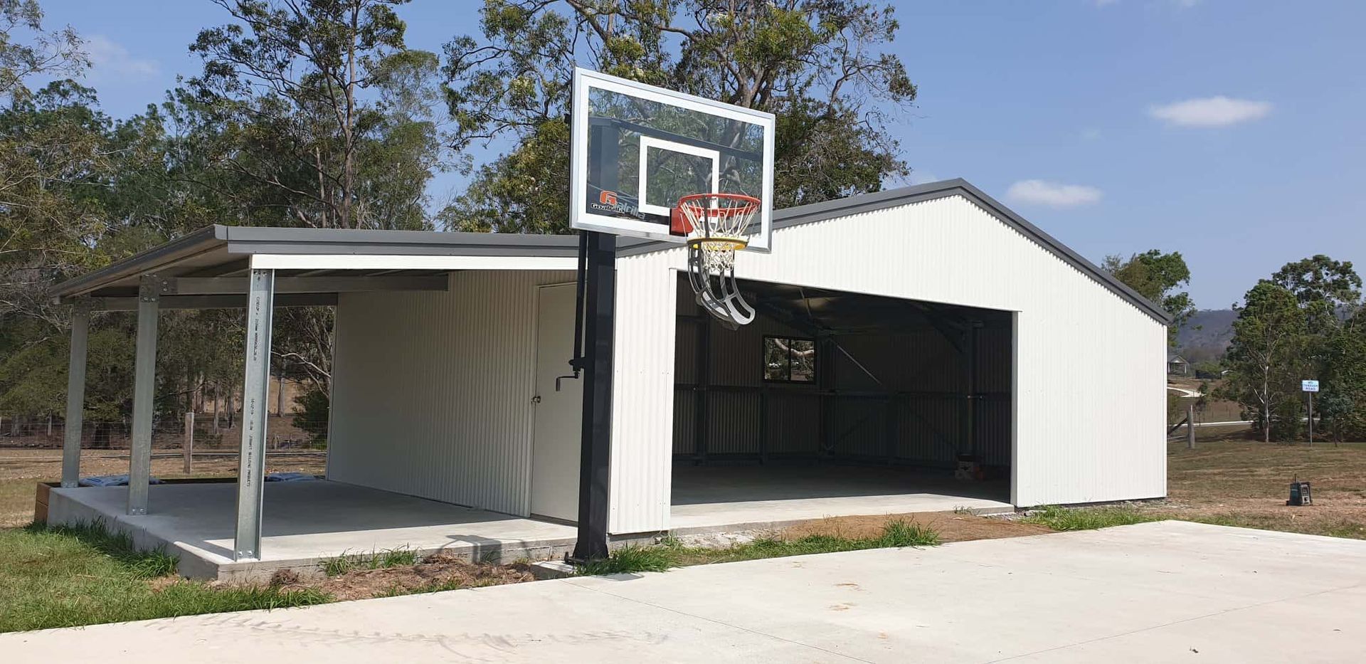 There is a basketball hoop in front of a garage. — Just Sheds In Kunda Park, QLD