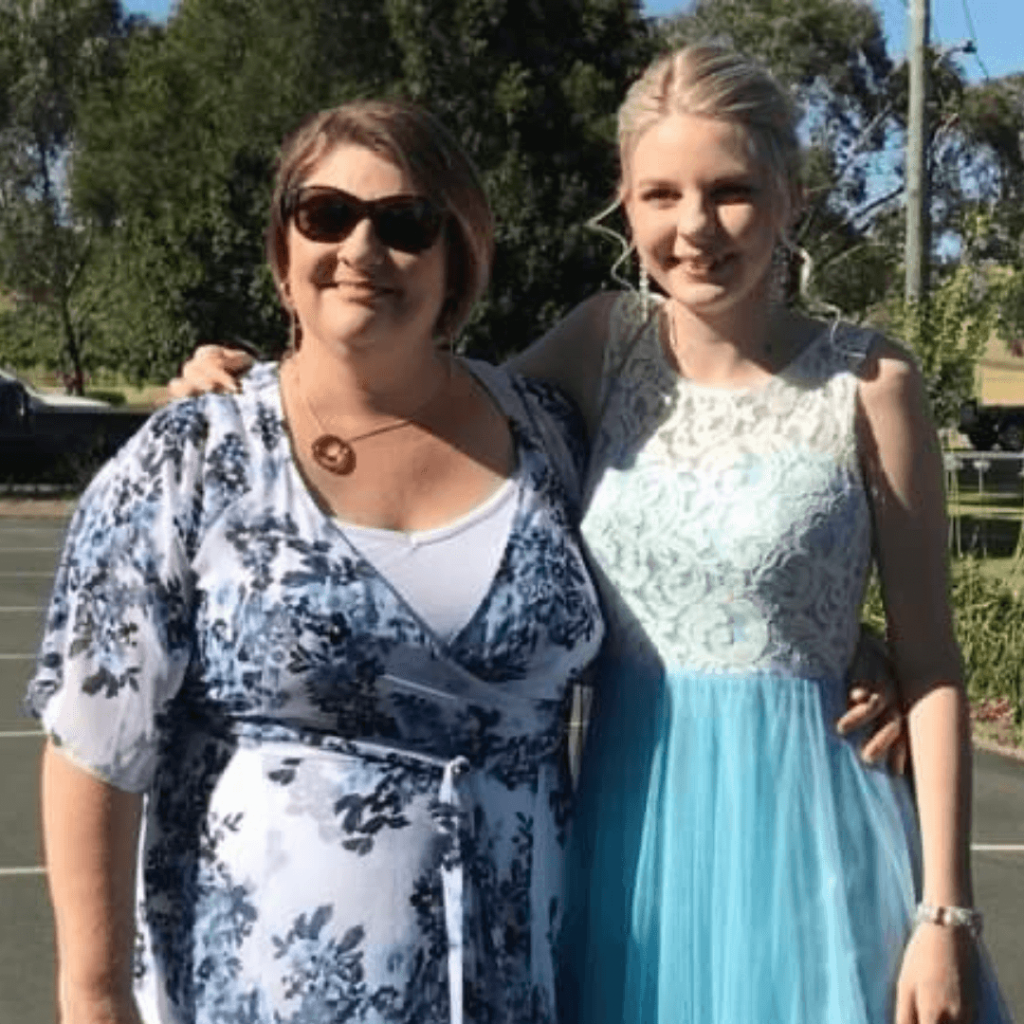 A Mother And Daughter Are Posing For A Picture In A Parking Lot — Howells & Co Legal & Conveyancing In Cessnock, NSW