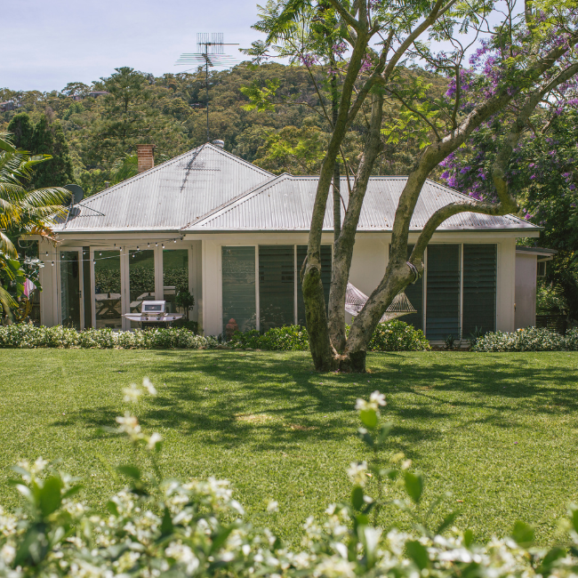 A White House With A Lush Green Lawn In Front Of It — Howells & Co Legal & Conveyancing In Cessnock, NSW