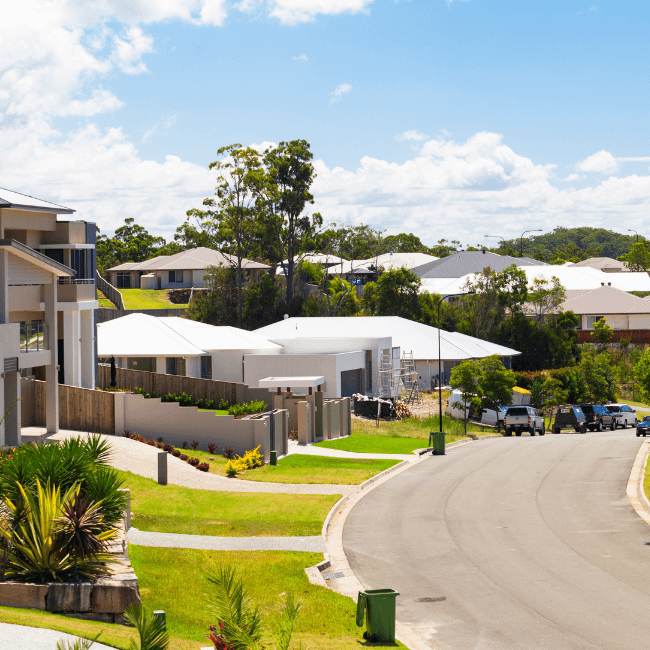 A Row Of Houses Are Lined Up On The Side Of A Road — Howells & Co Legal & Conveyancing In Cessnock, NSW