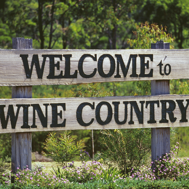 A Wooden Sign That Says Welcome To Wine Country — Howells & Co Legal & Conveyancing In Cessnock, NSW