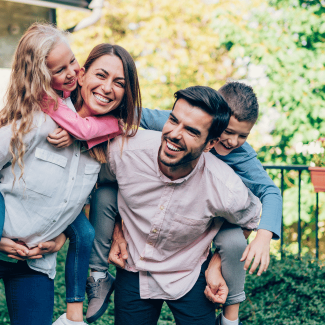 A Man Is Carrying Two Children On His Back — Howells & Co Legal & Conveyancing In Lake Cessnock, NSW